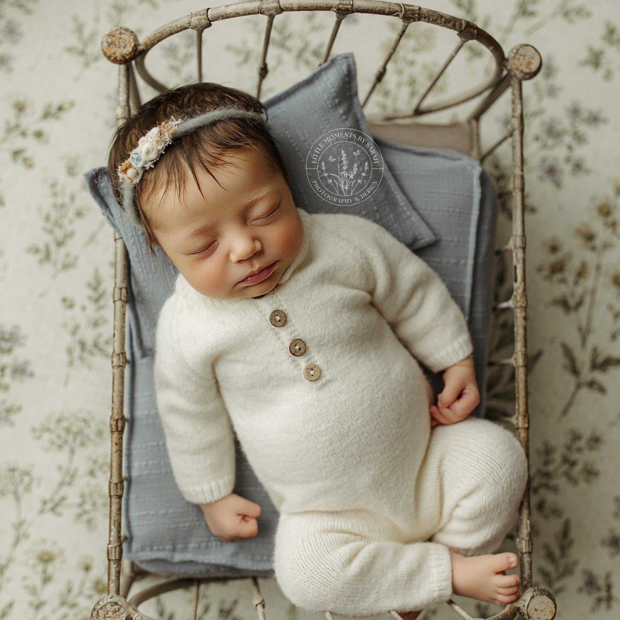 Dusty blue textured sheet and pillow set for newborn photography props, displayed in a vintage metal bed frame.