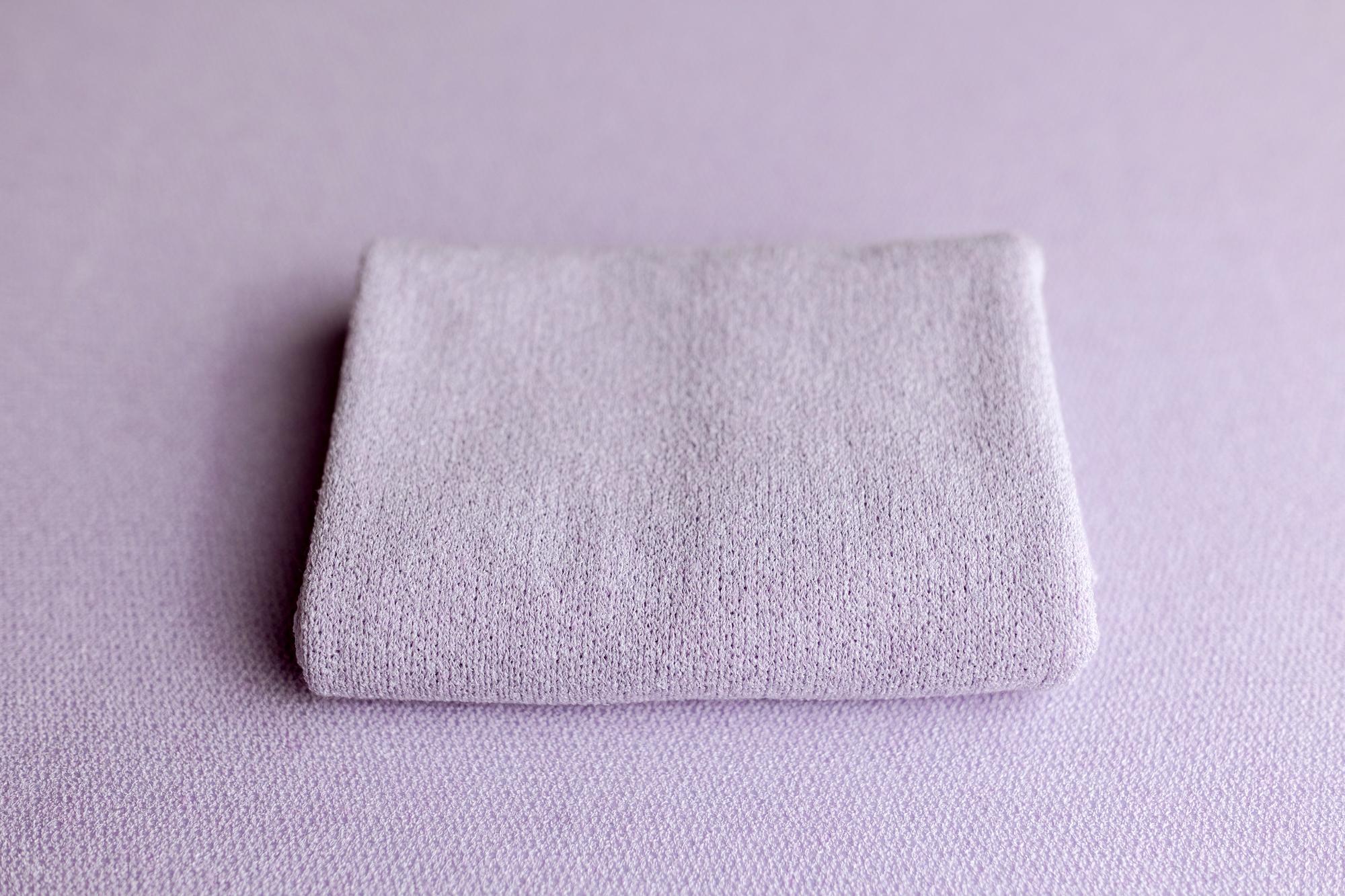 Soft, wisteria purple knit posing fabric and matching newborn photography wrap with a textured, stretchy finish.