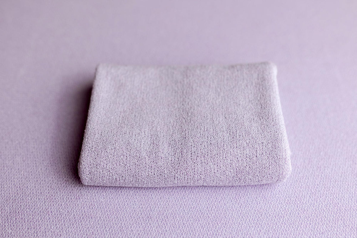 Soft, wisteria purple knit posing fabric and matching newborn photography wrap with a textured, stretchy finish.