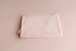 Soft blush pink newborn photography drop and wrap in a smooth, lightweight knit fabric for a seamless, minimal look.