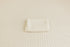 Off-white Veda newborn posing fabric with a delicate textured knit pattern and a matching folded wrap.