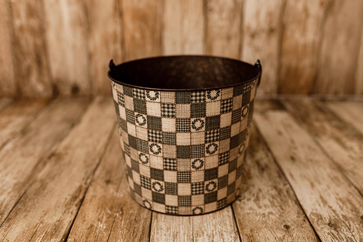 Hope Chest Christmas newborn photography bucket cover featuring vintage olive green and cream patchwork squares, gingham plaid, and little evergreen wreaths with rustic quilt stitching, displayed on a metal posing bucket.