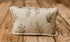 Mantle Garland newborn photography pillowcase featuring delicate evergreen branches, sage green botanical sprigs, and subtle rust-colored berries on a warm cream textured fabric, displayed on a rustic wooden farmhouse backdrop.