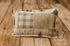 Home For the Holidays newborn photography pillowcase featuring vintage Christmas patchwork with evergreen trees, rustic plaid, and quilt blocks in warm cream, sage green, and muted rust tones, displayed on a wooden farmhouse backdrop.