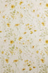 Ivory fabric backdrop with delicate watercolor yellow flowers and soft green foliage for newborn photography.