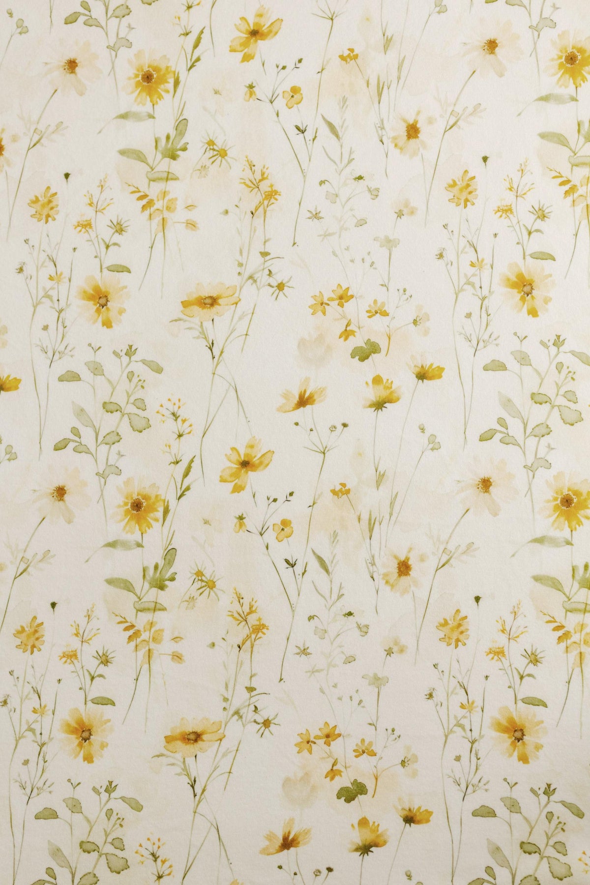 Ivory fabric backdrop with delicate watercolor yellow flowers and soft green foliage for newborn photography.