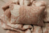 Textured newborn photography pillowcase in dusty rose and cream with a vintage-inspired woven floral pattern.
