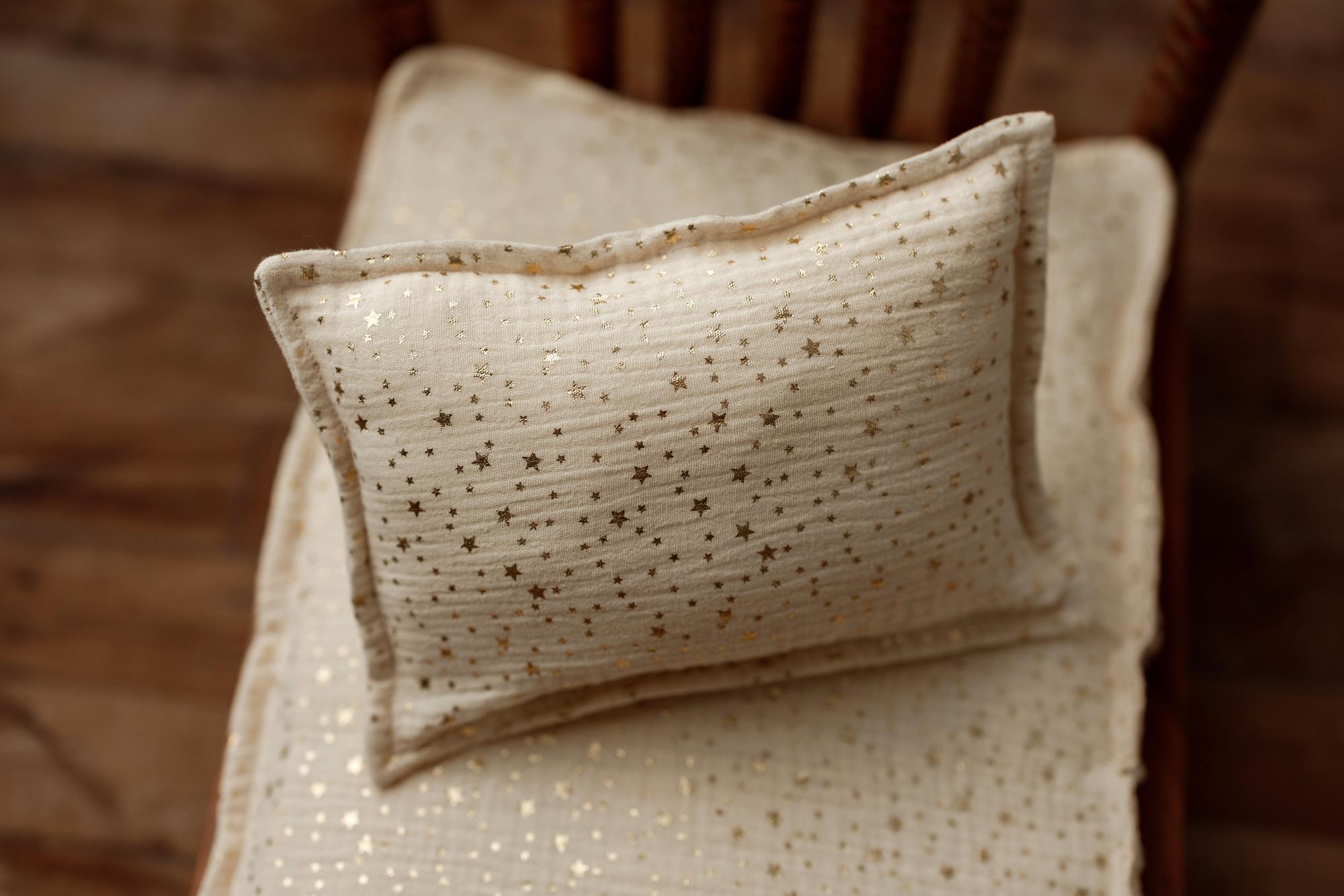 Ivory newborn photography mattress sheet and pillowcase set featuring a metallic gold star pattern on textured fabric.