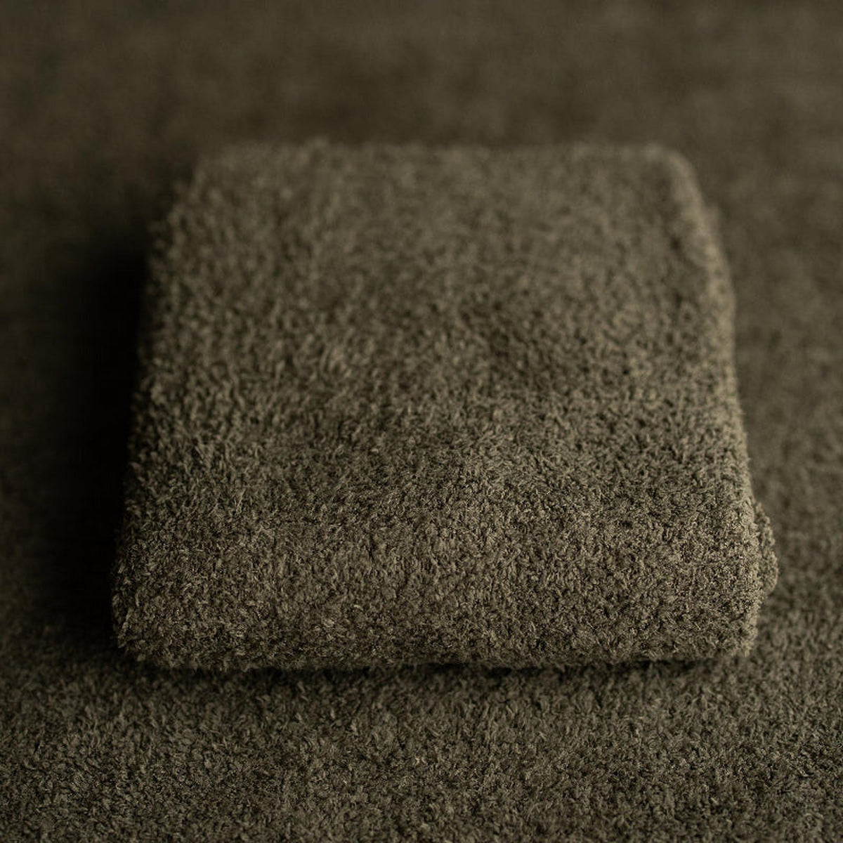Deep fir green newborn photography fabric with a soft, fluffy, and stretchy texture for organic setups.