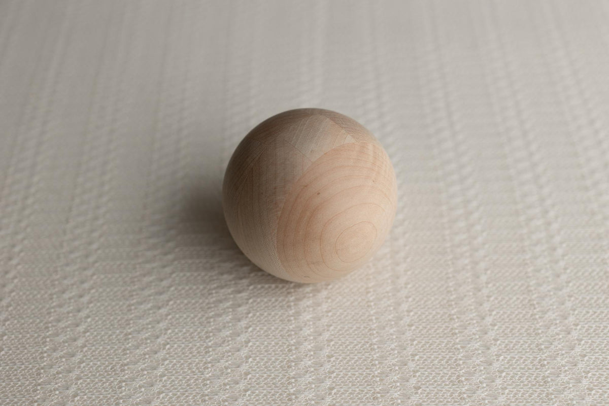 Soft ivory open-knit fabric posing wrap with a delicate, organic texture for newborn photography sessions.