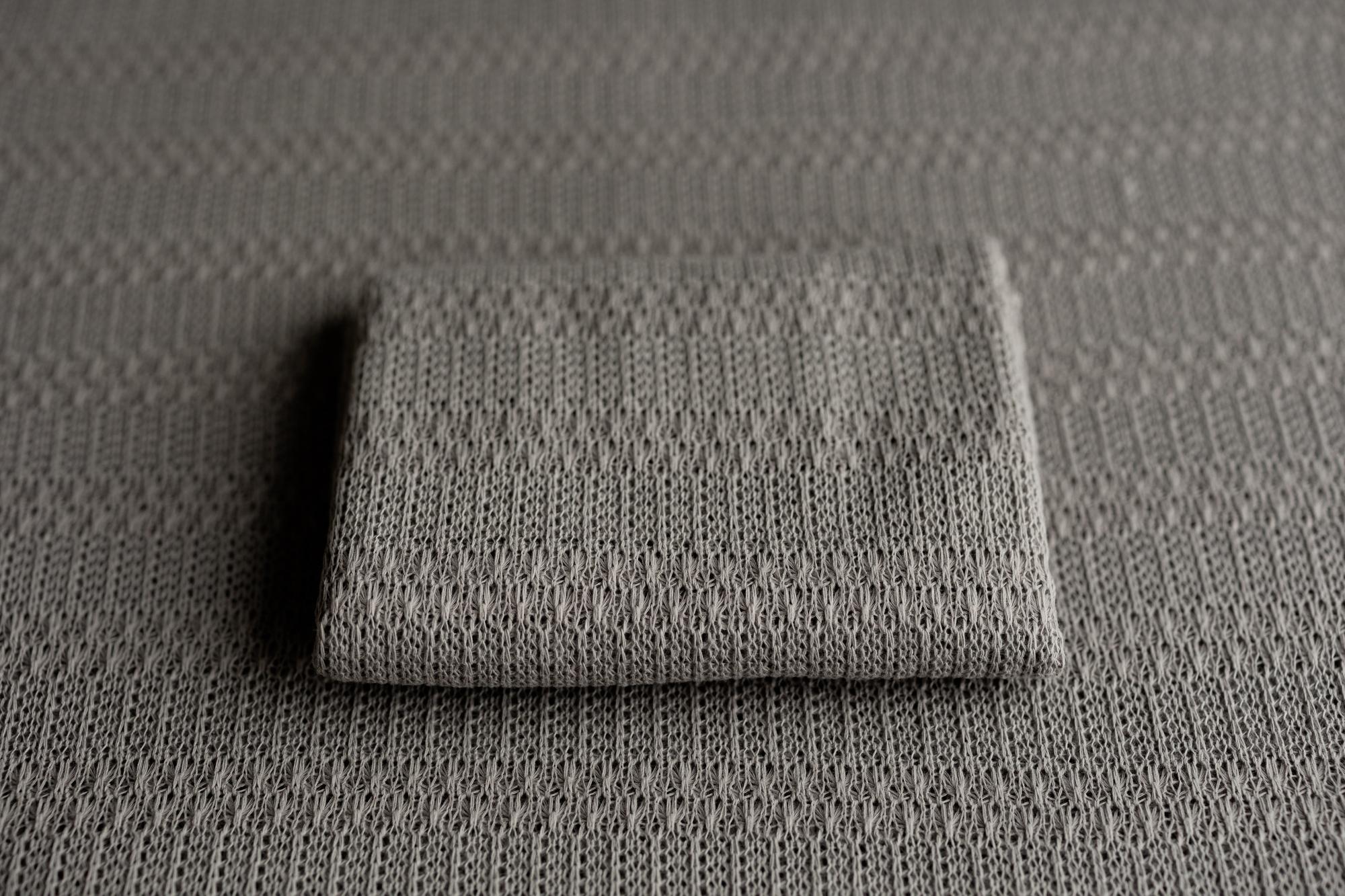 Storm gray textured knit newborn fabric drop and matching wrap with a soft, lightweight, and moody aesthetic.