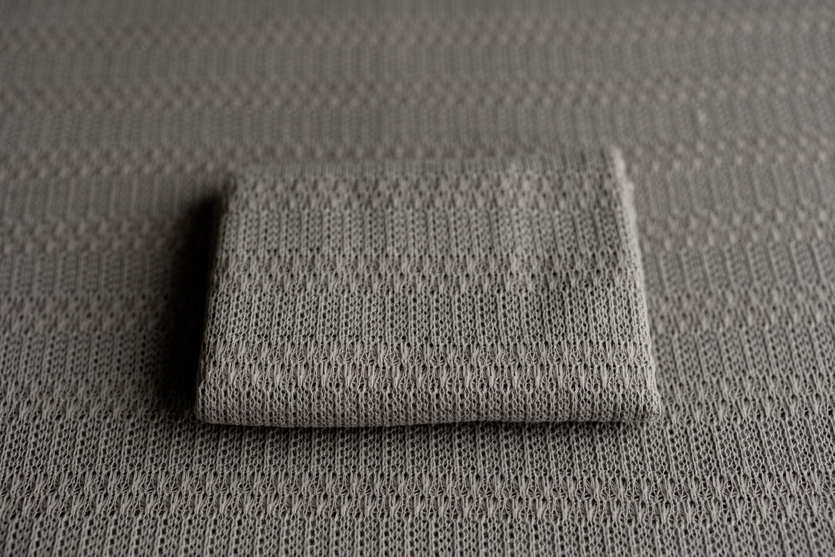 Storm gray textured knit newborn fabric drop and matching wrap with a soft, lightweight, and moody aesthetic.
