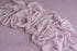 Muted lavender Nest textured fabric backdrop paired with a delicate, stretchy lace wrap for newborn photography.