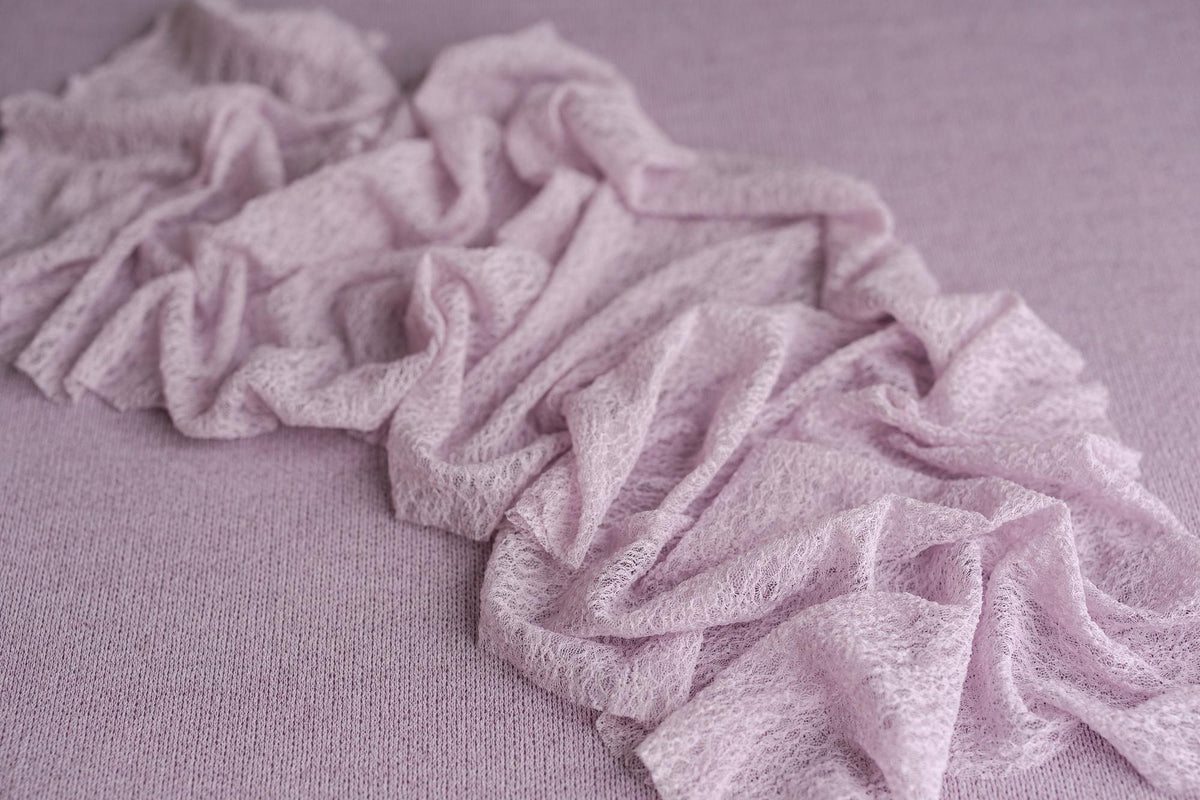 Muted lavender Nest textured fabric backdrop paired with a delicate, stretchy lace wrap for newborn photography.