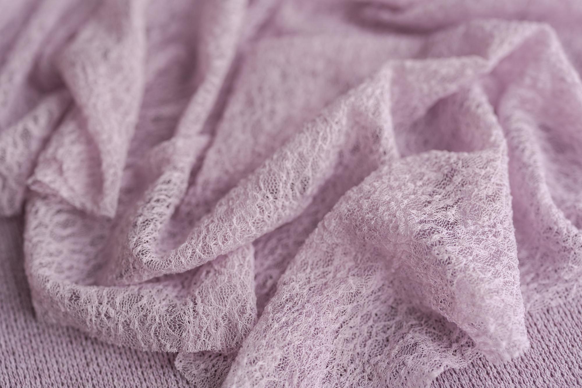 Soft, muted lavender stretchy lace wrap layered over cozy, textured Nest fabric for newborn photography.
