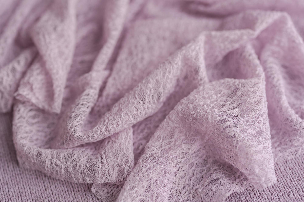 Soft, muted lavender stretchy lace wrap layered over cozy, textured Nest fabric for newborn photography.