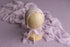 Muted lavender Nest fabric backdrop with a matching delicate, stretchy lace newborn wrap on a mannequin head.