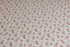 Textured white newborn posing fabric featuring a dainty pink and green floral pattern for photography backdrops.