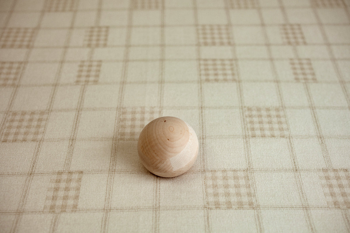 Grandpa's Twin beige plaid newborn posing fabric with wooden posing ball showing the soft oatmeal and cream check pattern for newborn photography.