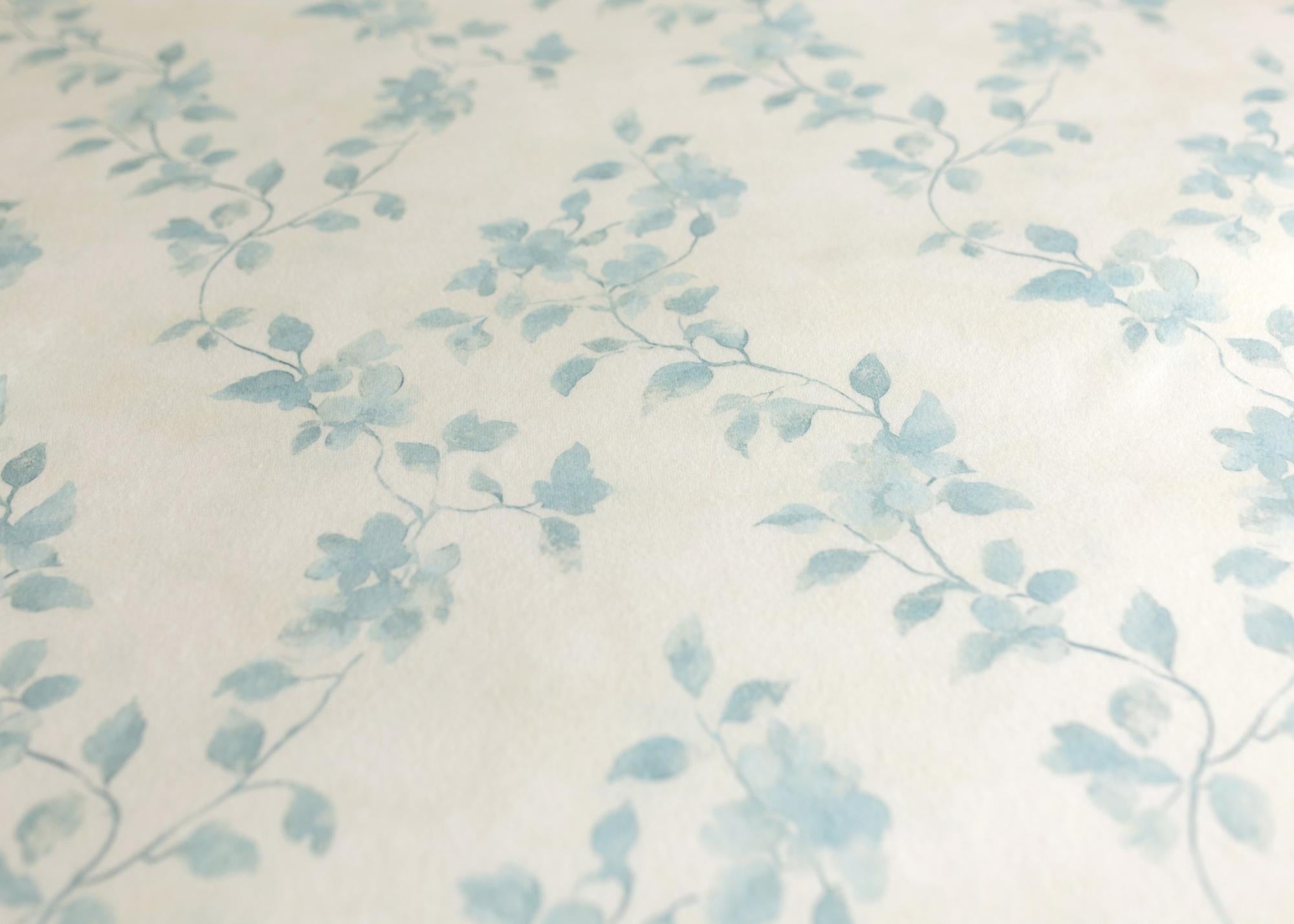 Soft ivory fabric featuring a delicate watercolor blue vine floral pattern for newborn photography props.