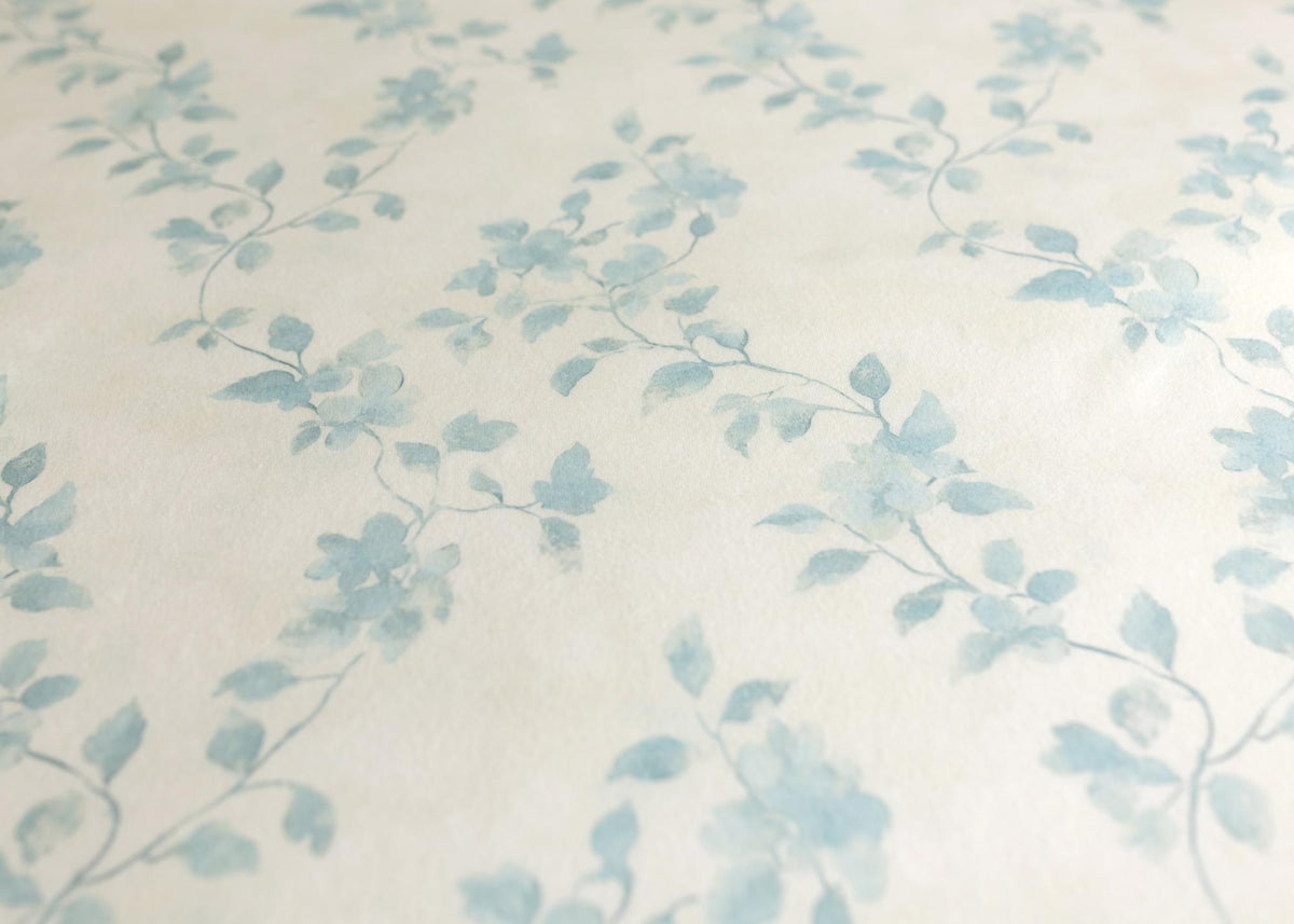 Soft ivory fabric featuring a delicate watercolor blue vine floral pattern for newborn photography props.