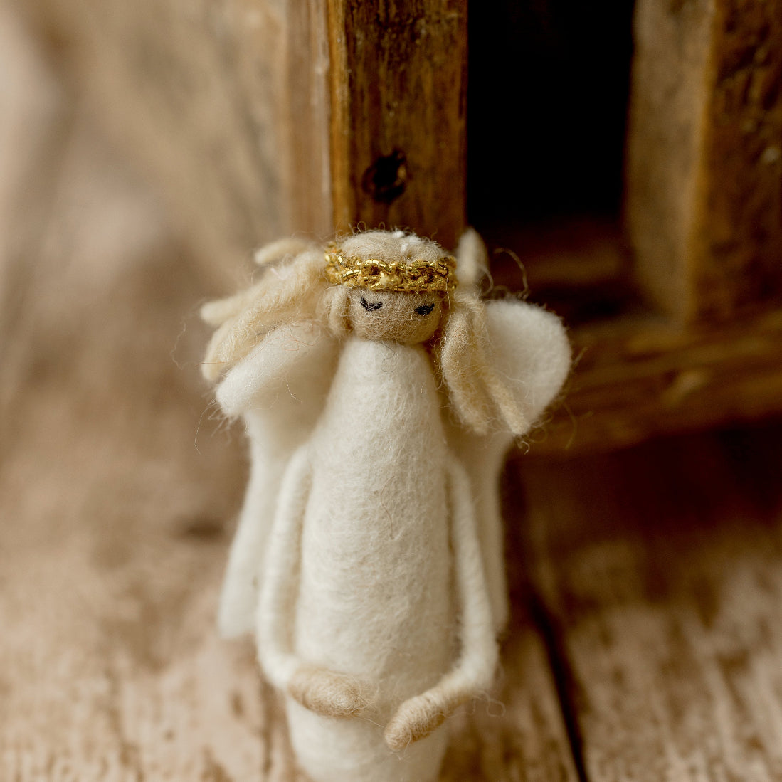 Handmade-style ivory felted angel newborn photography lovie with soft wings, embroidered face, and gold halo for Christmas sessions.