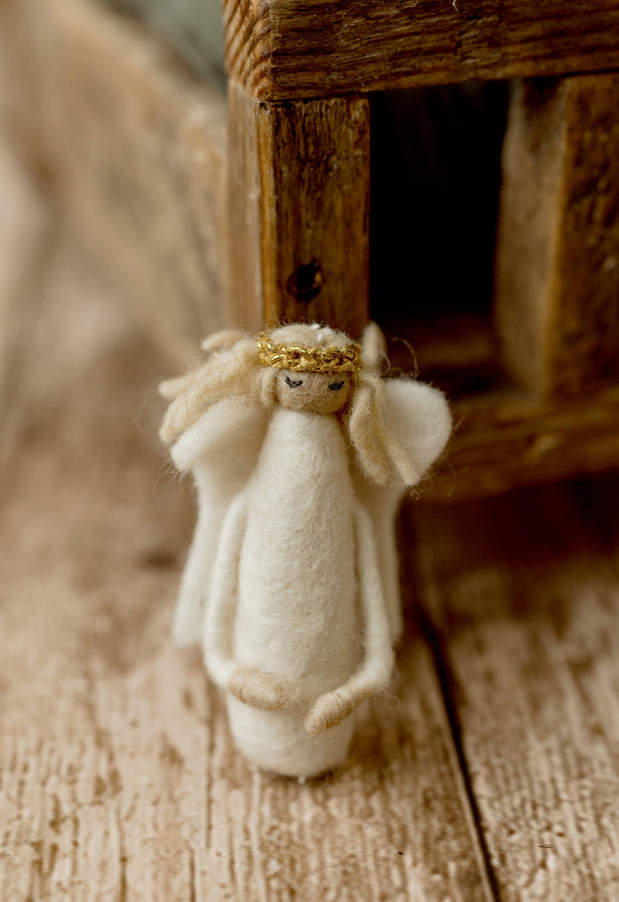 Handmade-style ivory felted angel newborn photography lovie with soft wings, embroidered face, and gold halo for Christmas sessions.