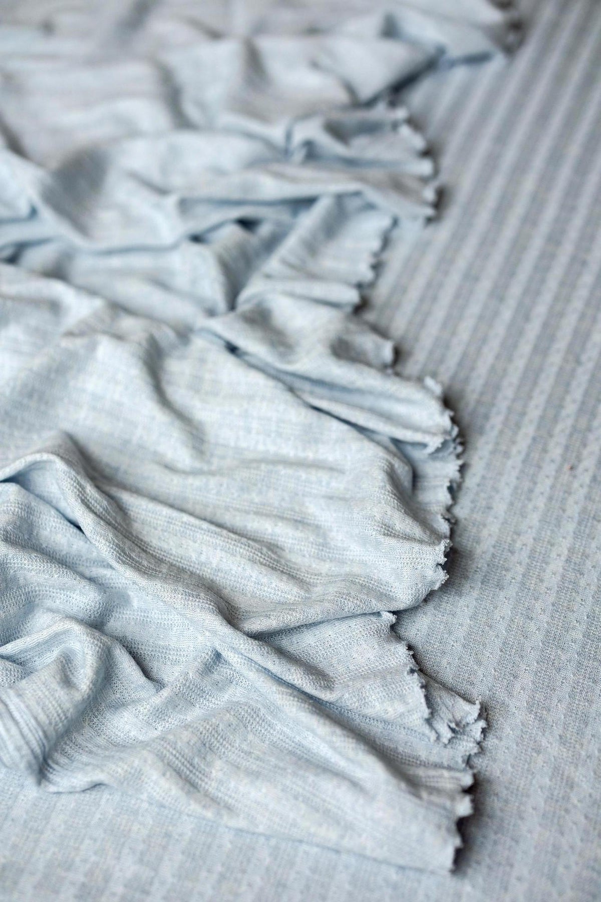 Sky blue newborn photography prop set featuring soft, ribbed fabric with delicate ruffled edges and a textured finish.