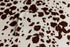 Soft, cream-colored posing fabric with a brown cow print pattern, folded neatly on a matching background.