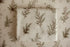 Close-up of Mantle Garland cream newborn posing fabric and coordinating wrap featuring delicate evergreen branches and botanical details used for newborn photography.