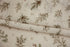 Close-up of Mantle Garland cream newborn posing fabric and coordinating finished edge wrap featuring delicate evergreen branches and botanical details.