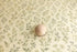 Hayden Floral posing fabric with sage green and blue wildflowers on a cream background with a wooden sphere prop.