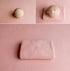 Soft blush pink newborn photography drop and wrap set featuring a lightly textured knit fabric and matching tieback.