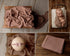 Soft brown-toned purple newborn wrap in a lightweight, textured stretch knit fabric for photography styling.