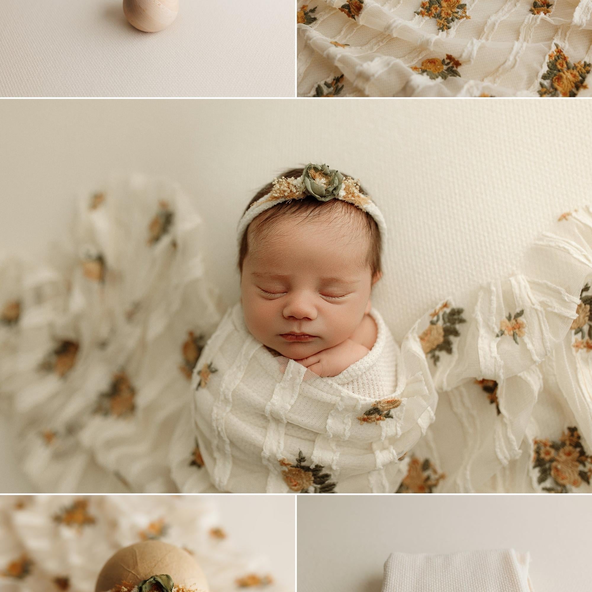 Newborn wrapped in creamy waffle knit fabric with floral accents and a matching floral headband for photography.