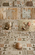 A collage of coordinated baby photography props and textiles in a neutral Christmas palette, including a knit baby romper, patterned blankets, and a baby lying on a matching quilted fabric backdrop.