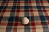 Patriot Plaid newborn photography posing fabric featuring vintage navy blue, burgundy red, and cream plaid with a rustic distressed texture, styled with a wooden posing ball for scale.