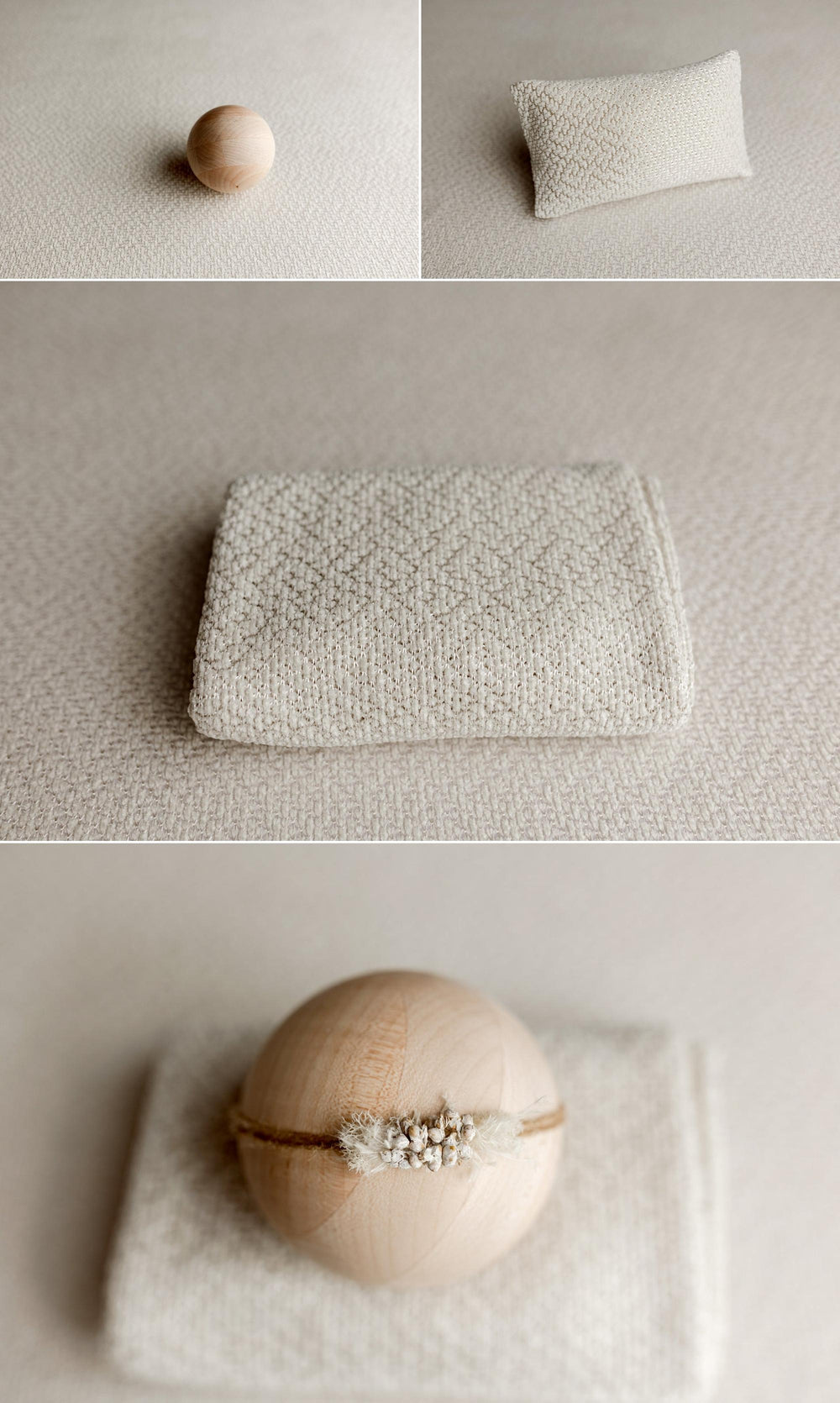 A soft cream-colored textured fabric accessory, shown folded and laid flat on a neutral fabric backdrop, with a small wooden ball and a pillow-like prop in the background.