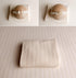 Creamy ivory ribbed newborn photography wrap and drop set with delicate openwork detail and matching floral headband.