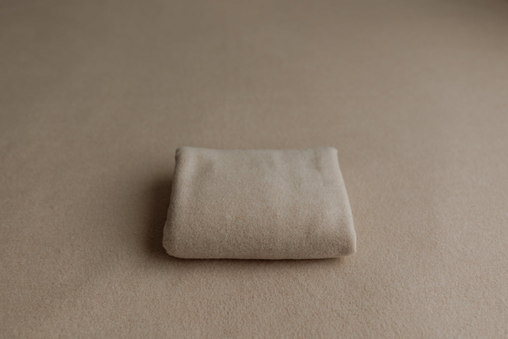 Sand-colored newborn posing fabric with matching wrap for photography sessions