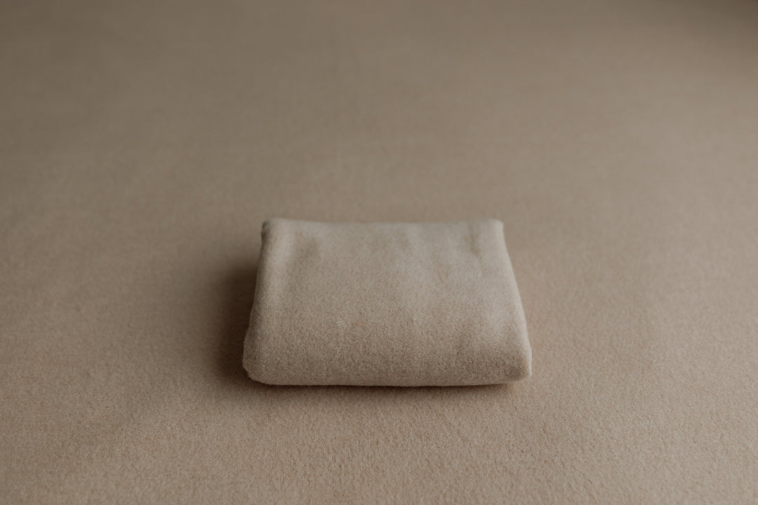 Sand-colored newborn posing fabric with matching wrap for photography sessions