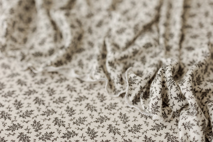 Close-up of Ditzy floral posing fabric with soft drape for newborn photography