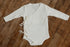 Ivory ribbed kimono-style sitter romper with side ties and long sleeves, designed for 6–12 month milestone photography sessions.