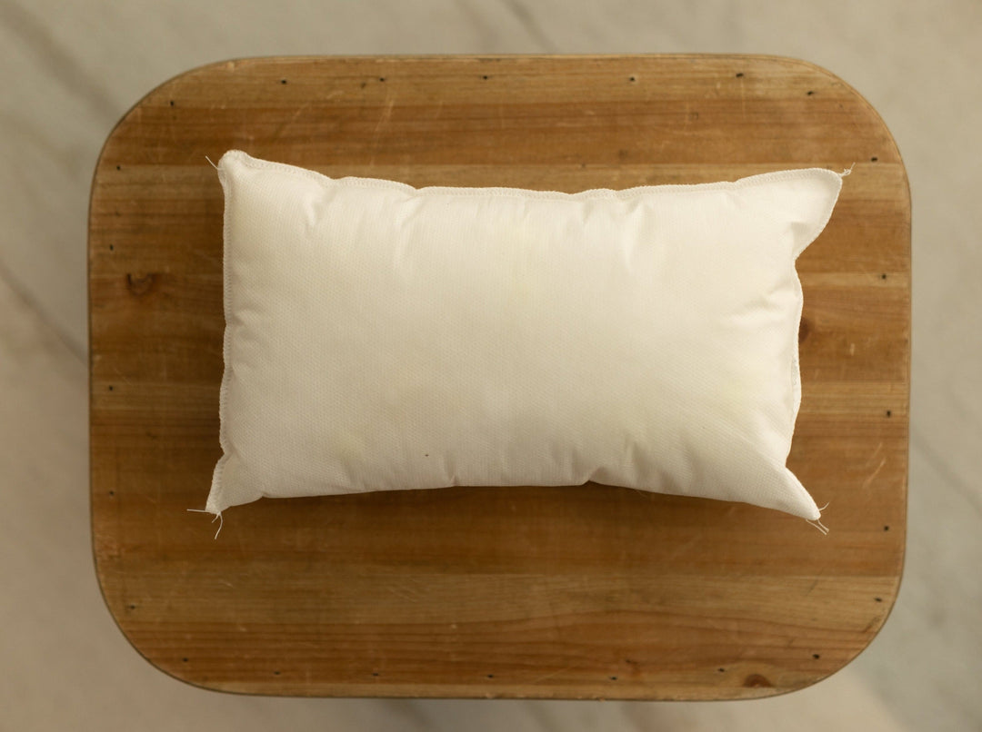 Rectangular white pillow insert for newborn photography, designed to be used inside pillow cases for safe and cozy posing setups.